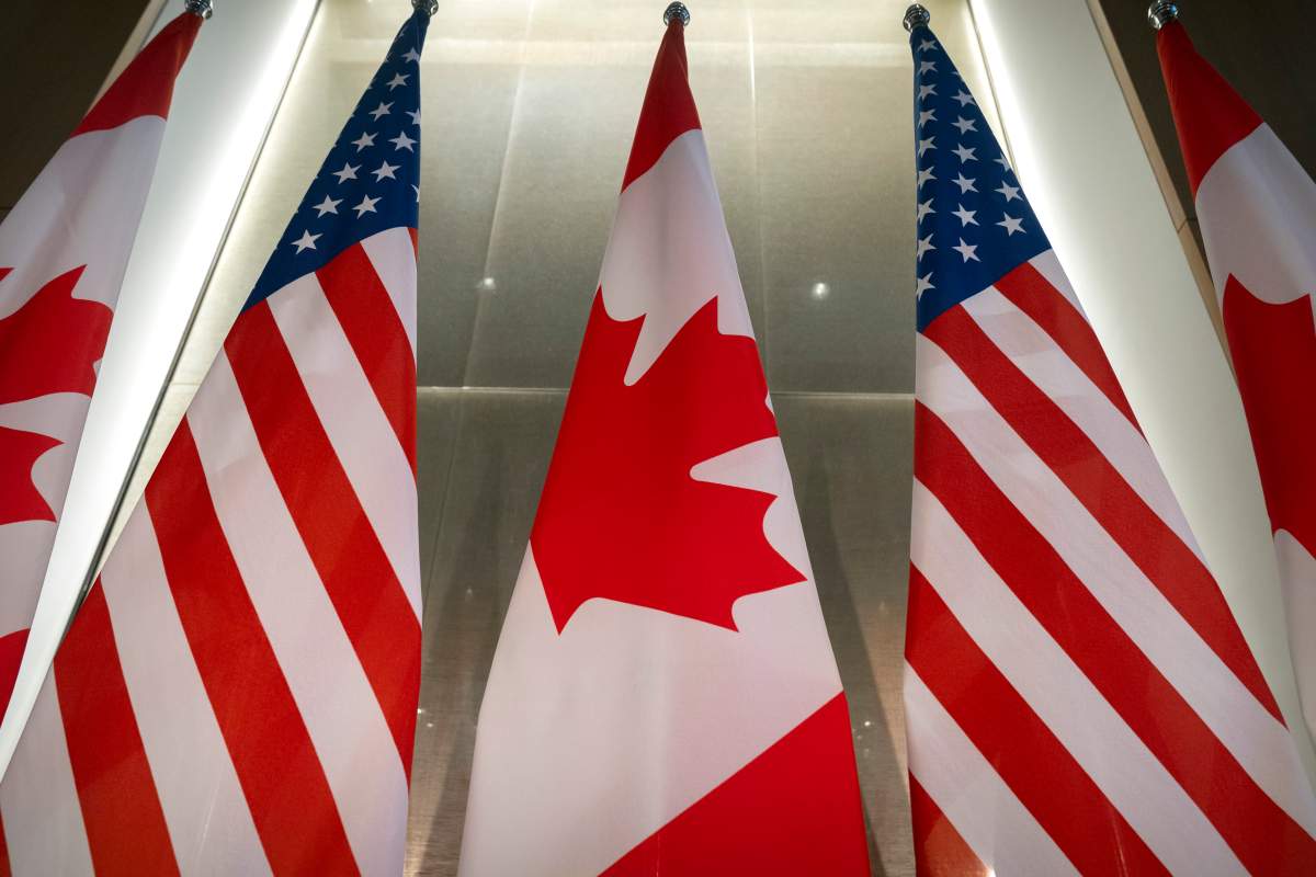 U.S. and Canadian flags are displayed.