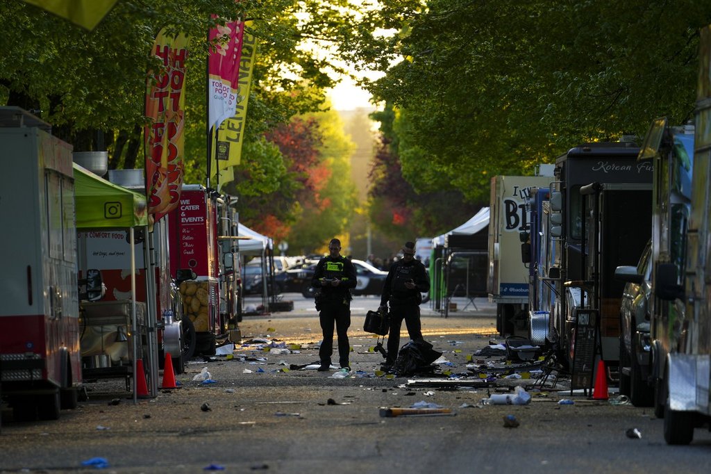 Members of the Vancouver Police forensics team examine the scene where a vehicle drove into a crowd at a Lapu Lapu Day street festival Saturday evening in Vancouver, Sunday, April 27, 2025. Shock and grief rippled through Canada's Filipino community on Sunday as members struggled to come to grips with an attack at a cultural street festival in Vancouver on Saturday that killed 11 people and injured dozens more.