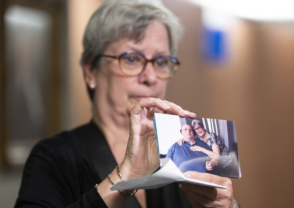 Sylvie Brosseau shows a photo of her herself with her husband at the courthouse in Montreal.