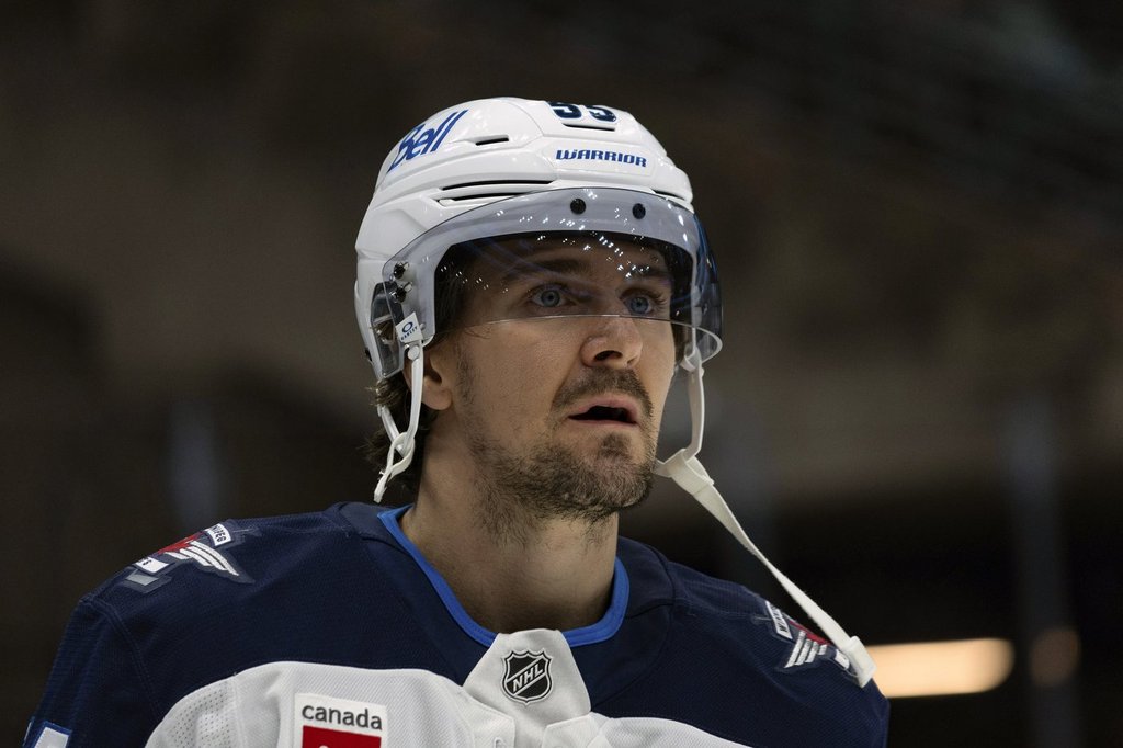 Winnipeg Jets centre Mark Scheifele stands on the ice during warm-ups before an NHL hockey game against the Utah Hockey Club, Monday, Jan. 20, 2025, in Salt Lake City. (AP Photo/Melissa Majchrzak).