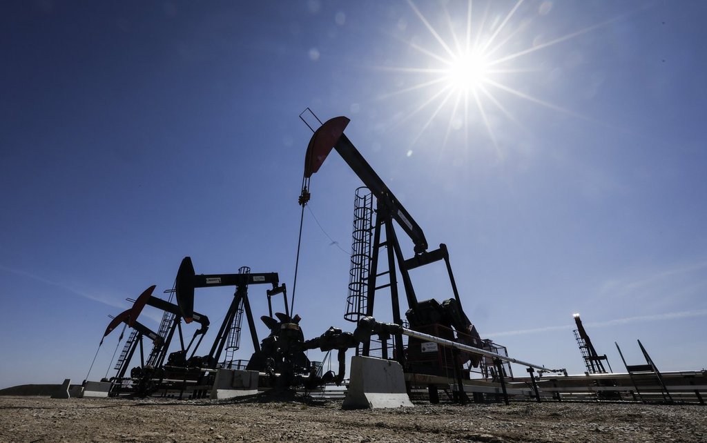 A pumpjack draws out oil and gas from a well head near Calgary on May 6, 2025.