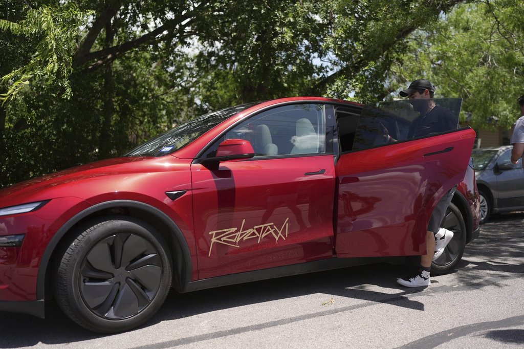 A rider boards a driverless Tesla robotaxi, a ride-booking service, Sunday, June 22, 2025, in Austin, Texas.
