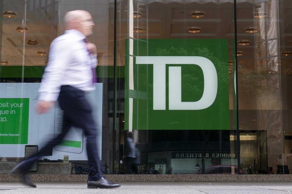 A person makes their way past a Toronto-Dominion Bank in the Financial District of Toronto, Monday, Aug. 14, 2023. THE CANADIAN PRESS/Spencer Colby.