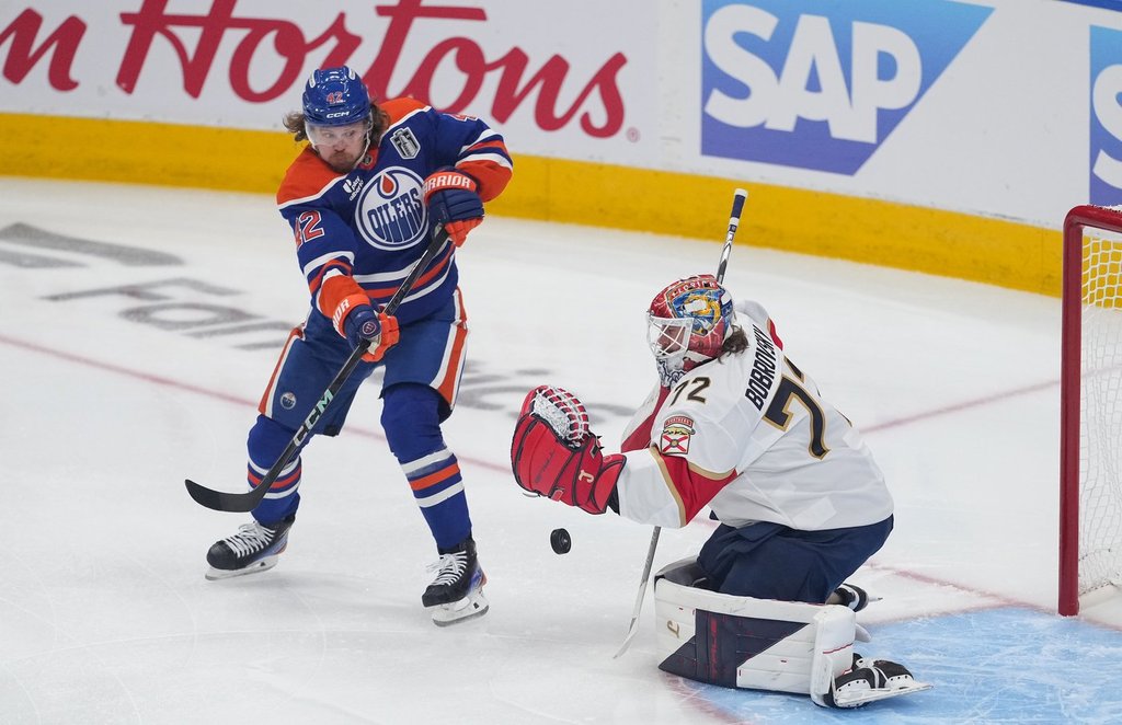 Oilers winger Kasperi Kapanen (42) tries to redirect the puck as Florida Panthers goalie Sergei Bobrovsky (72) makes the save in Game 1 of Stanley Cup final in Edmonton on Wednesday, June 4, 2025.