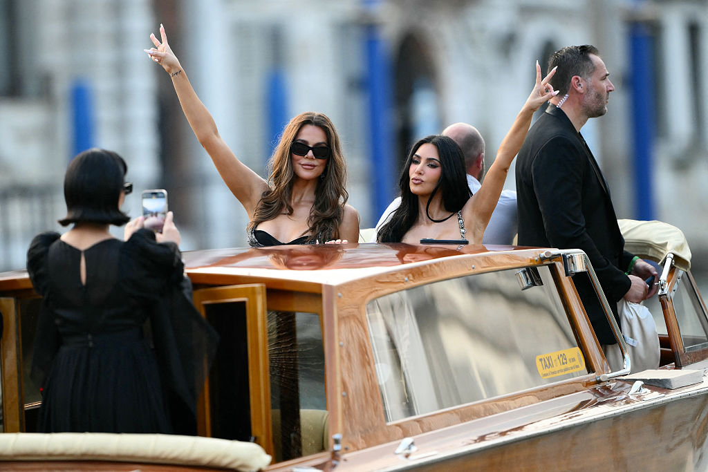 Kris Jenner takes pictures of Khloe and Kim Kardashian on a taxi boat as they leave the Gritti Palace Hotel ahead of the wedding of Amazon's founder Jeff Bezos with Lauren Sanchez in Venice on June 26, 2026.