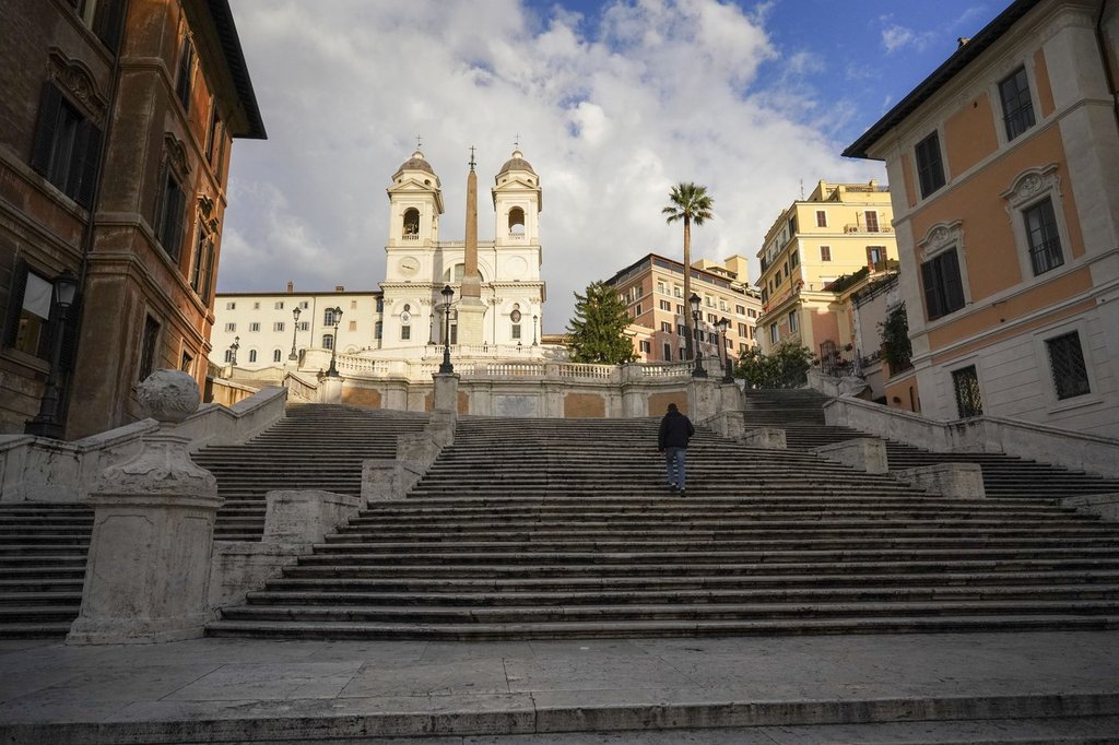 FILE - A man walks up the historical Spanish Steps, in Rome, Friday, Nov. 20, 2020.