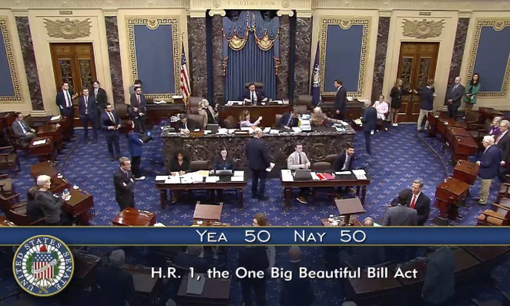 In this image from video from Senate Television, Vice President JD Vance, seated center, breaks a 50-50 tie to push President Donald Trump’s big tax breaks and spending cuts bill over the top, on the Senate floor at the U.S. Capitol, Tuesday, July 1, 2025, in Washington. (Senate Television via AP)