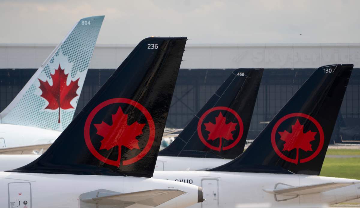 Air Canada logos are seen on the tails of planes at the airport in Montreal on Monday, June 26, 2023.