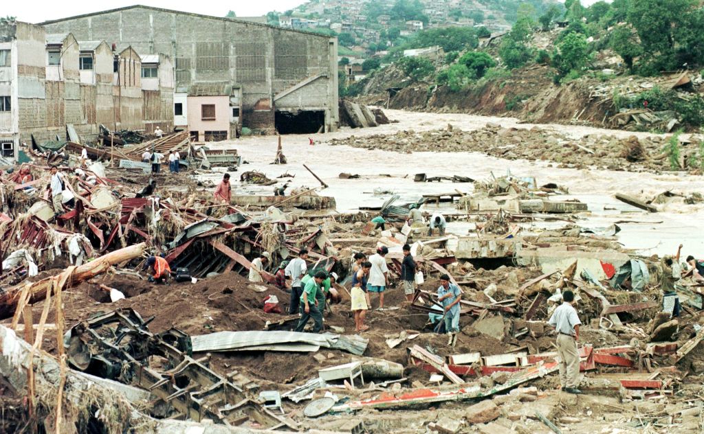 Local residents look through the remains of several businesses that were completely destroyed after being flooded by the rising waters of the Choluteca River that runs through Honduras.