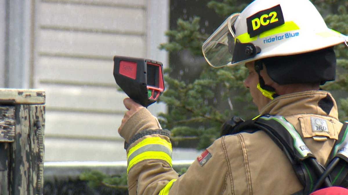 A firefighter checks for hot spots after a fire caused serious damage to a duplex in the northeast Calgary community of Falconridge on Monday.