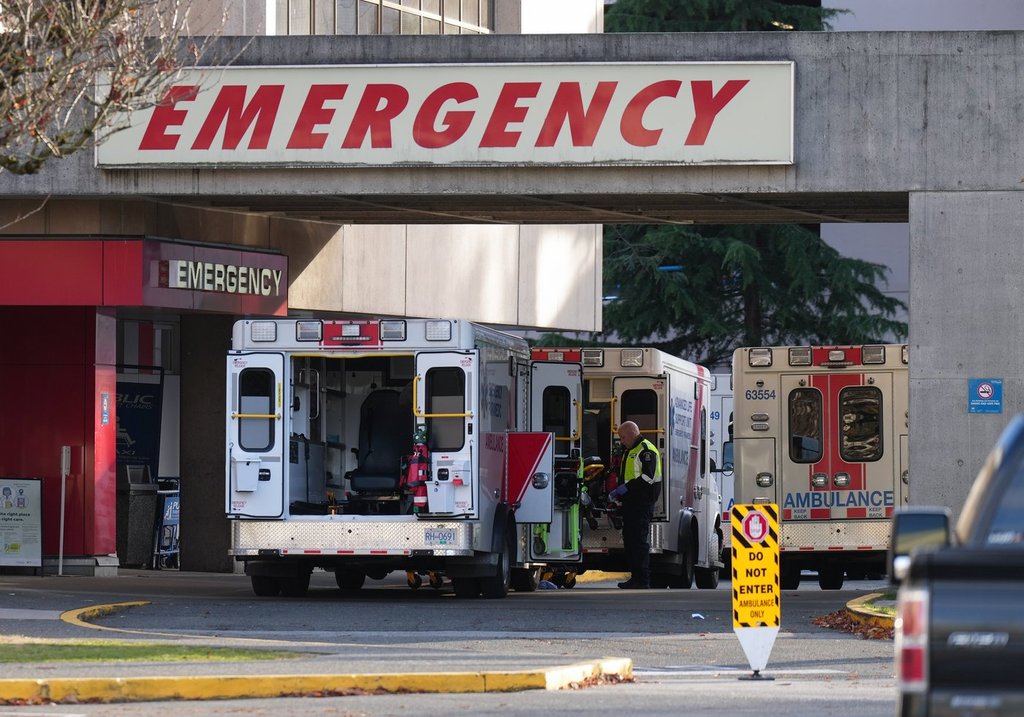 A paramedic is seen outside ambulances parked at the entrance to the emergency department at Richmond General Hospital, in Richmond, B.C., Sunday, Nov. 27, 2022. THE CANADIAN PRESS/Darryl Dyck.
