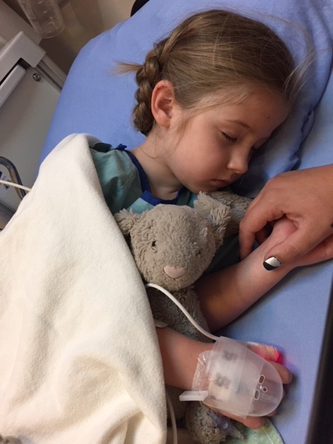 A young girl in a hospital bed
