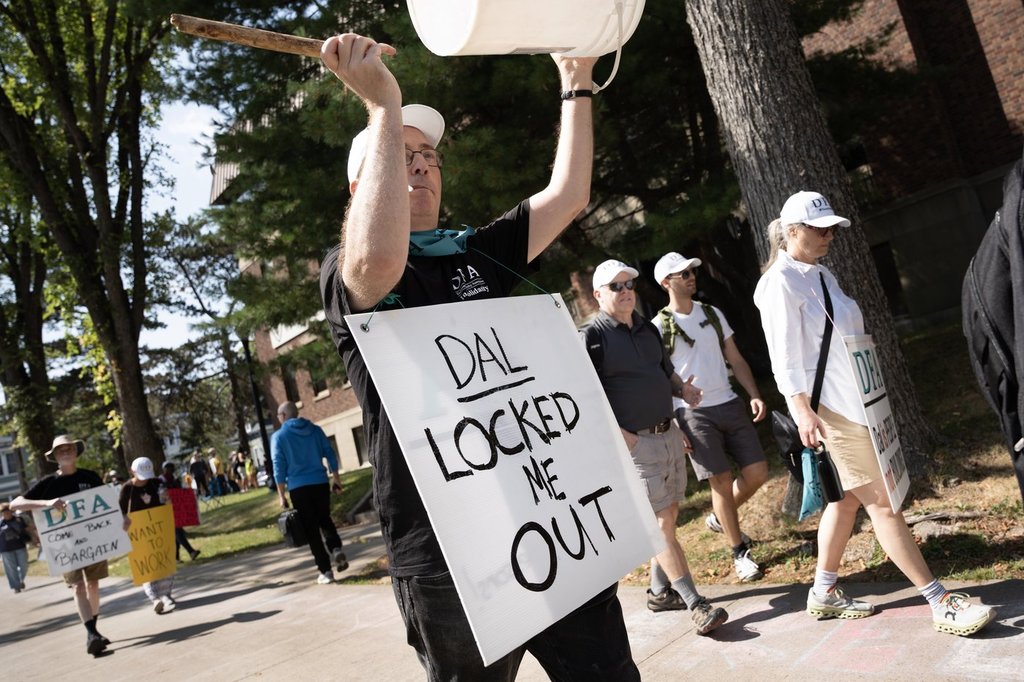 Members of the Dalhousie Faculty Association walk a picket line as students arrive on campus to begin the school year at Dalhousie University in Halifax, Tuesday, Sept. 2, 2025. The first day of school was cancelled for most Dalhousie University students after the university locked members out over a contract dispute. THE CANADIAN PRESS/Darren Calabrese.