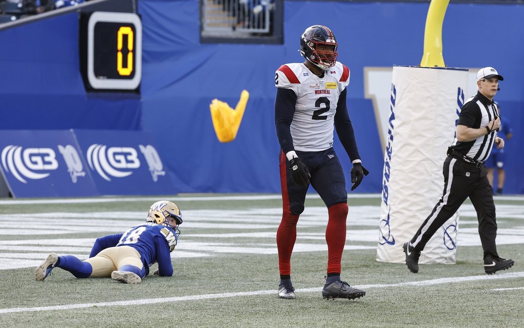 Montreal Alouettes' Shawn Oakman (2) gets called for roughing the passer as Winnipeg Blue Bombers' kicker Jamieson Sheahan (18) lies in his end zone during second half CFL action in Winnipeg Saturday, October 25, 2025.    THE CANADIAN PRESS/John Woods.