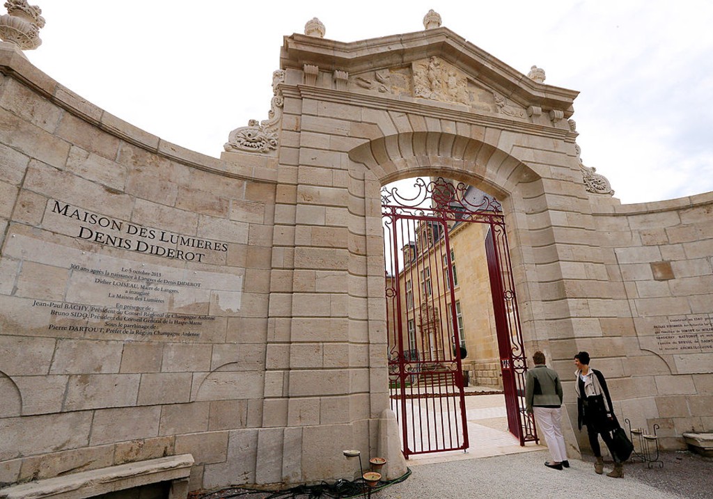 People stand outside the entrance of 'La Maison des Lumieres' (the House of the Enlightenment) on October 4, 2013 in in Langres, central France,