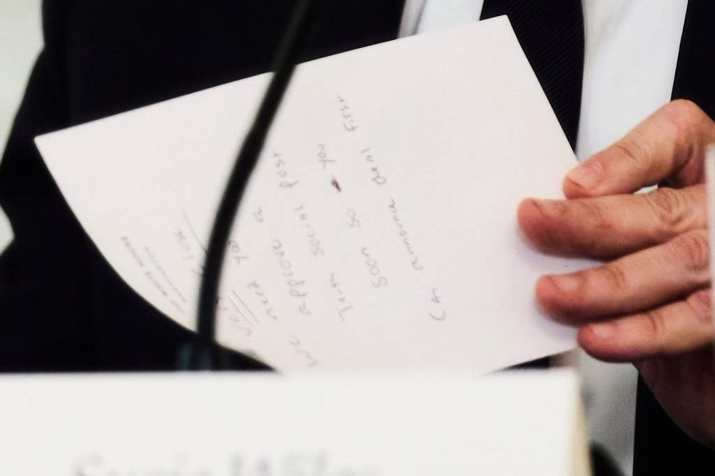 Secretary of State Marco Rubio writes a note before handing it to President Donald Trump during a roundtable meeting on antifa in the State Dining Room at the White House, Wednesday, Oct. 8, 2025, in Washington. (AP Photo/Evan Vucci)
