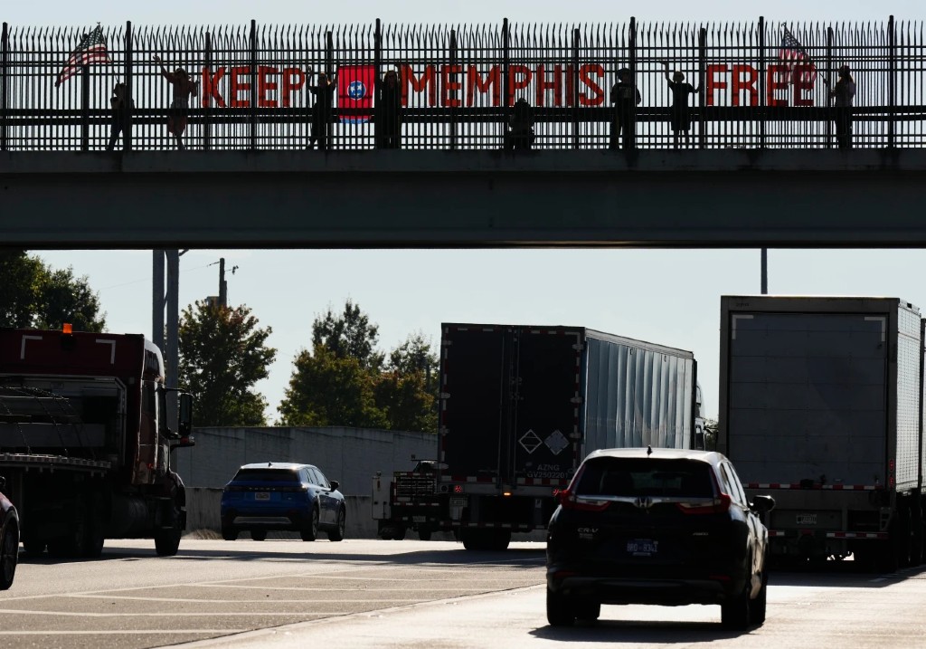 People demonstrate above Interstate 40 in Nashville, Tenn., Friday, Sept. 26, 2025, against the deployment of the National Guard in Memphis.