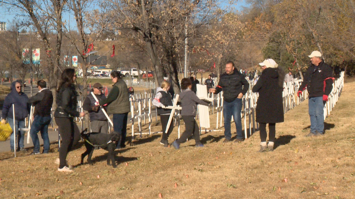 Volunteers set up for the annual field of crosses
