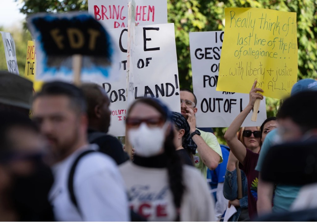 People protest outside a U.S. Immigration and Customs Enforcement facility on Sunday, Sept. 28, 2025, in Portland, Ore.