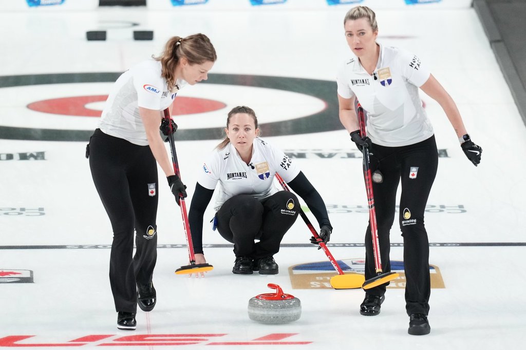 Rachel Homan, centre, throws a rock during Canadian Olympic curling trials action against Team Brown in Halifax, Tuesday, Nov. 25, 2025. THE CANADIAN PRESS/Darren Calabrese.