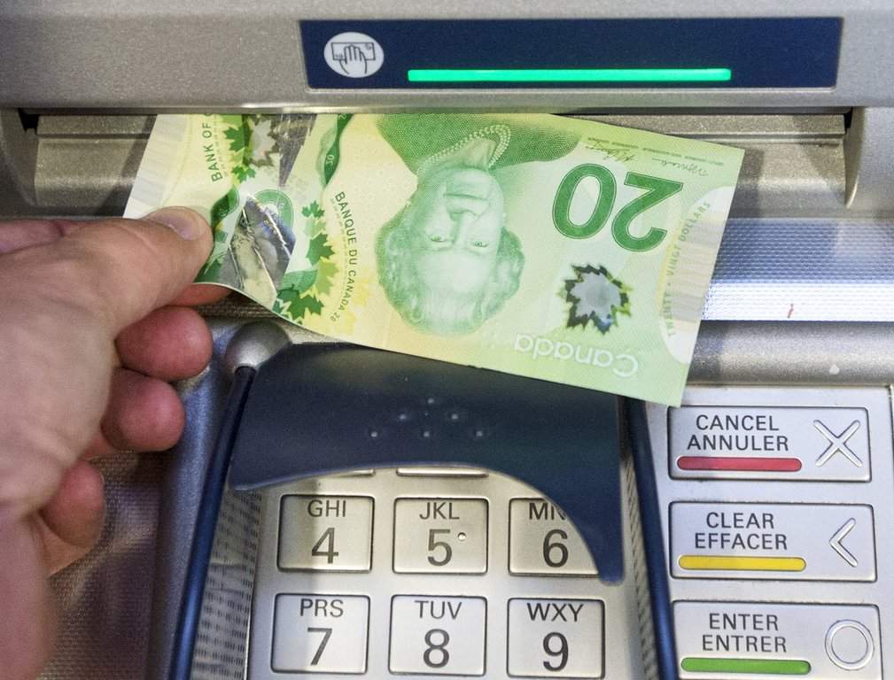 Twenty dollar bill put into an ATM machine
