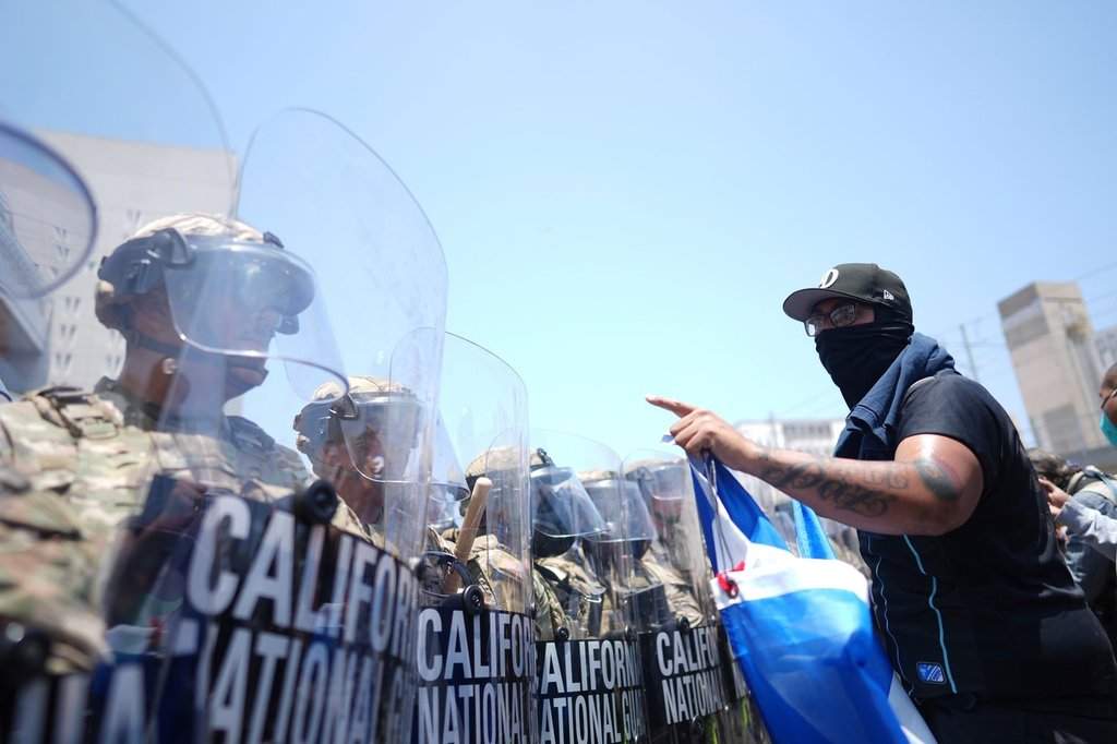 FILE - A protester confronts a line of U.S. National Guard in the metropolitan detention center of downtown Los Angeles, June 8, 2025, following last night's immigration raid protest.