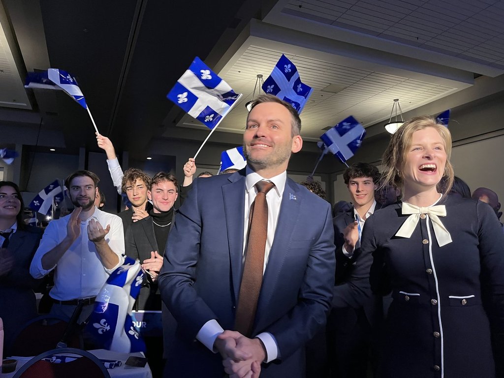 PQ leader Paul St-Pierre Plamondon with his wife, Alexandra Tremblay, in front of a crowd of PQ supporters gathered in Sherbrooke this weekend for a meeting of the Parti Québécois National Council.