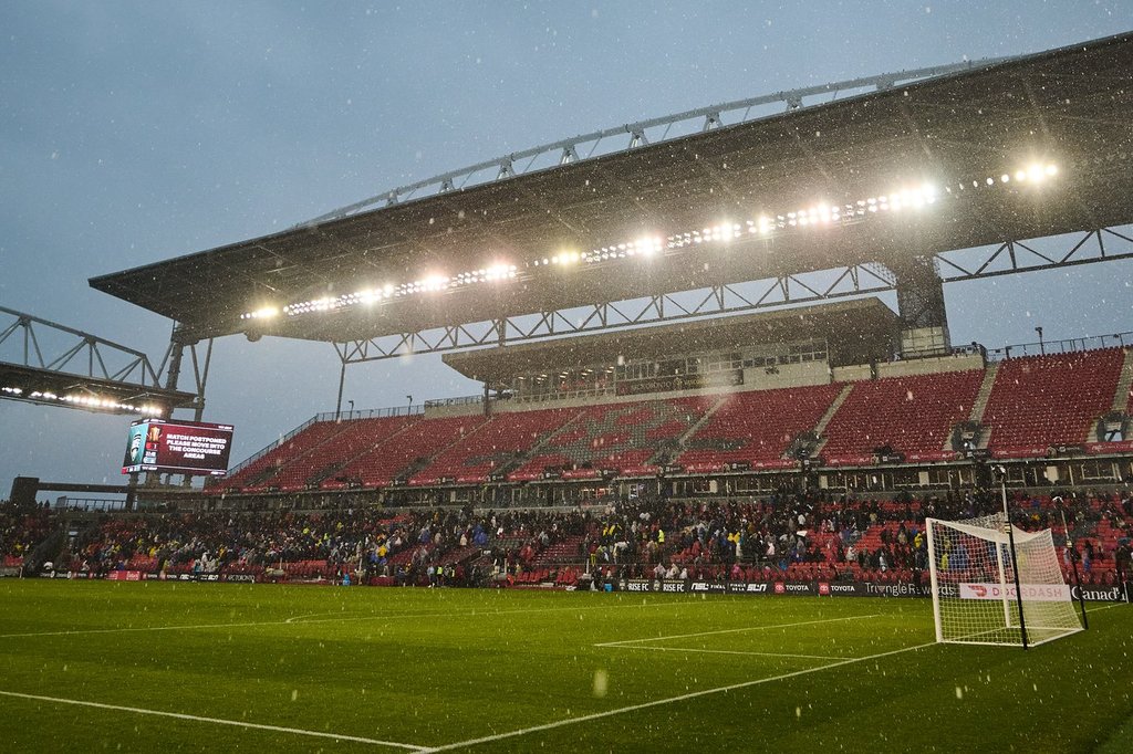 Fans clear the stands in heavy rain after the match was postponed due to a weather delay during the first half of the 2025 NSL final in Toronto, on Saturday, Nov. 15, 2025. THE CANADIAN PRESS/Sammy Kogan.