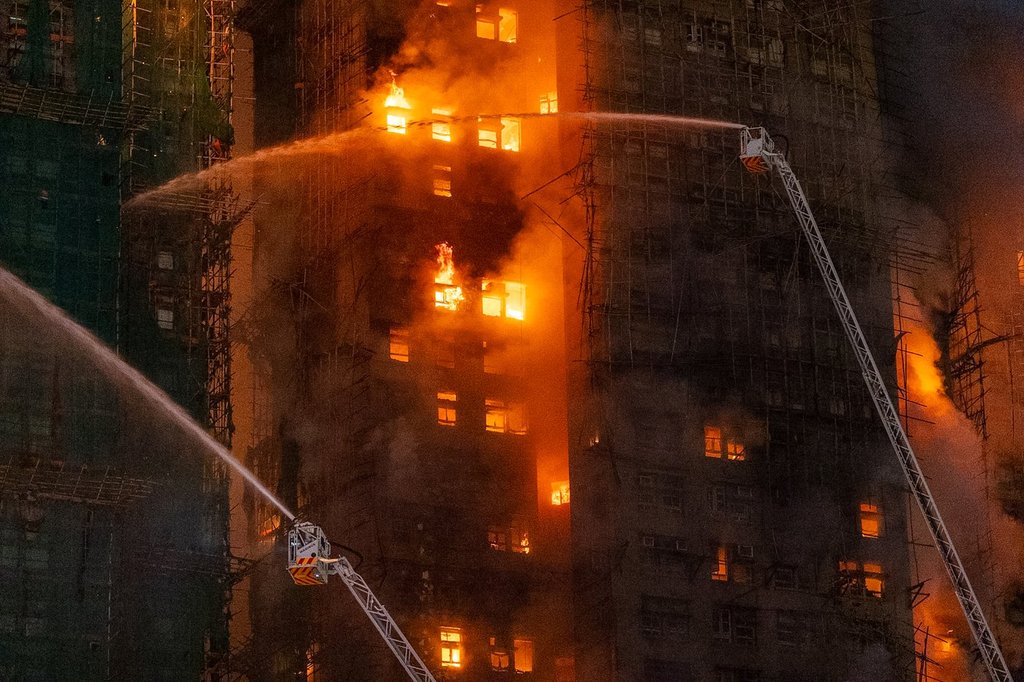 Firefighters try to extinguish a flames engulfing a building after a fire broke out at Wang Fuk Court, a residential estate in the Tai Po district of Hong Kong's New Territories, Wednesday, Nov. 26 2025.