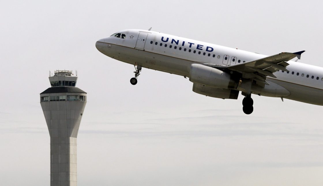 A United Airlines jet departs in view of the air traffic control tower at Seattle-Tacoma International Airport