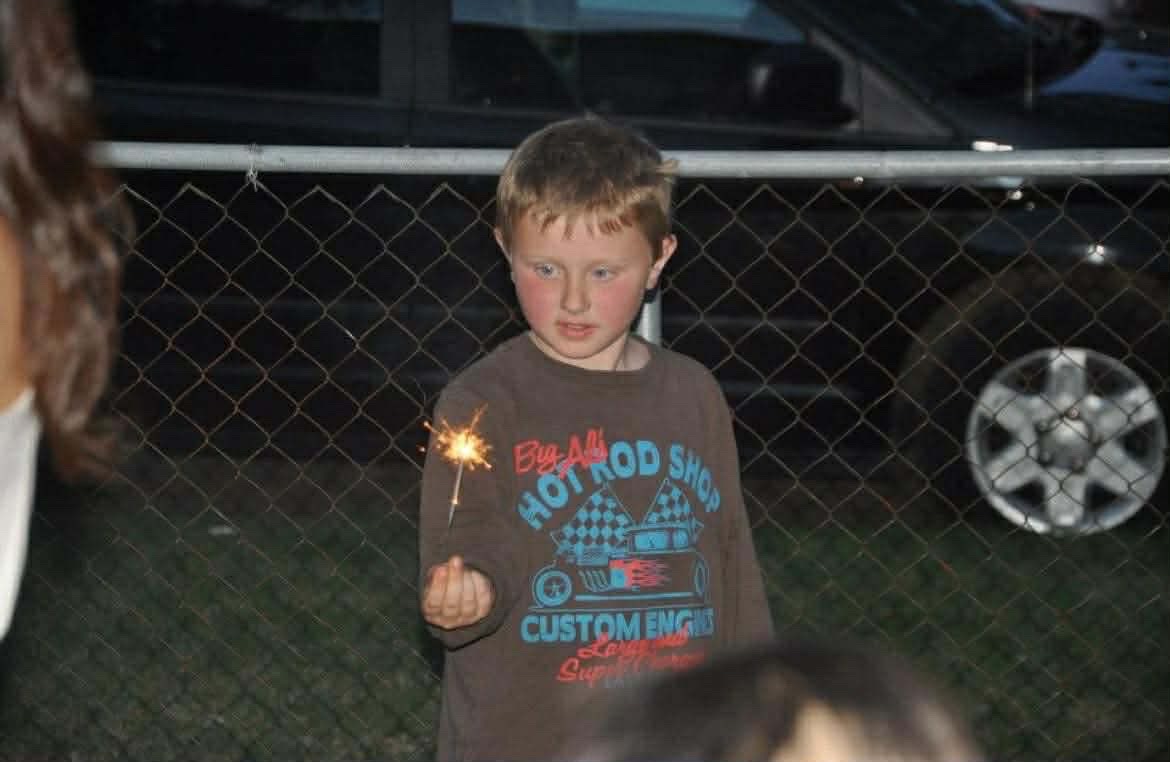 Undated photo of Caleb Berry as a child holding a sparkler.