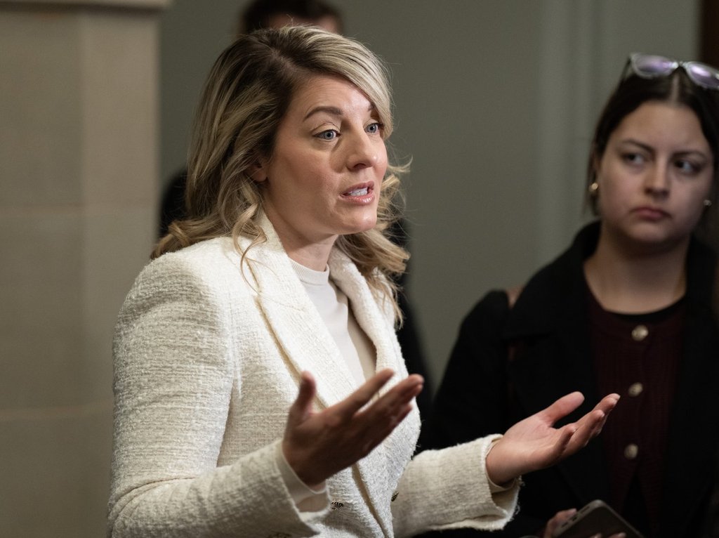 Industry Minister Melanie Joly speaks with reporters as she makes her way to a cabinet meeting on Parliament Hill, in Ottawa, Tuesday, Nov. 18, 2025.
