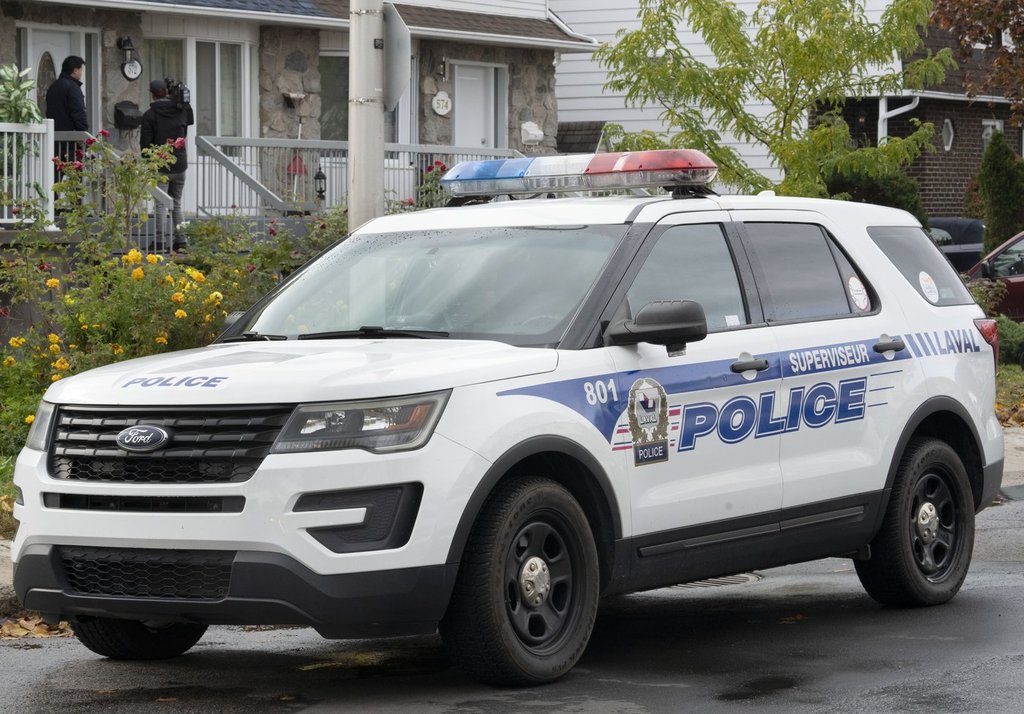 A police vehicle is shown outside a house in Laval, Que., Tuesday, Oct. 18, 2022. THE CANADIAN PRESS/Ryan Remiorz.