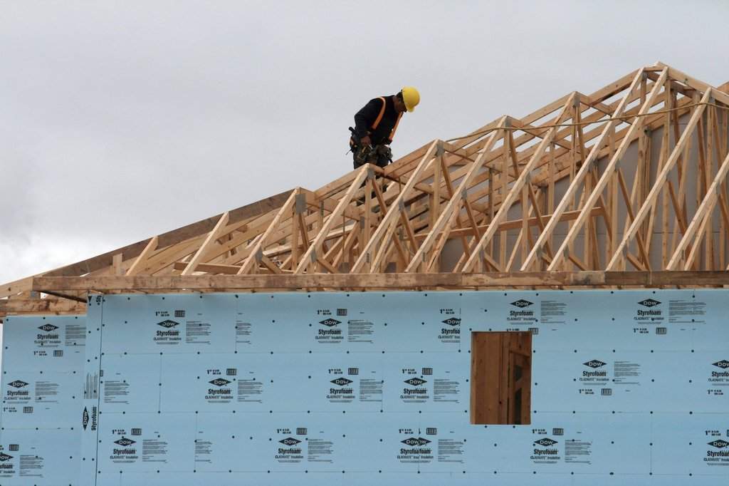A construction worker works on a house in a new housing development in Oakville, Ont. 