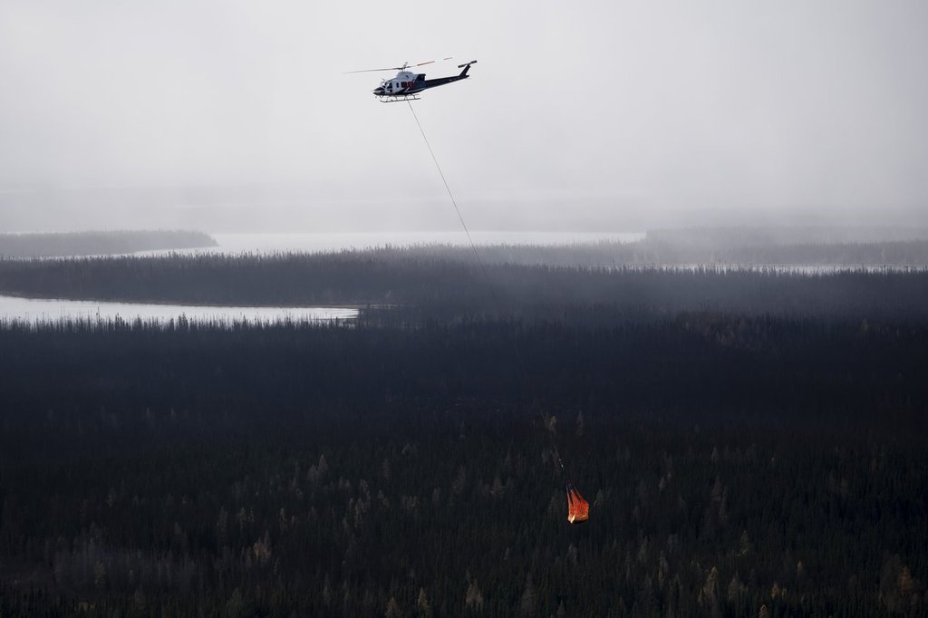 A helicopter moves equipment fuel between work sites near the Ring of Fire mineral deposit in the James Bay lowlands of northern Ontario, Friday, Oct. 24, 2025. THE CANADIAN PRESS/Christopher Katsarov.