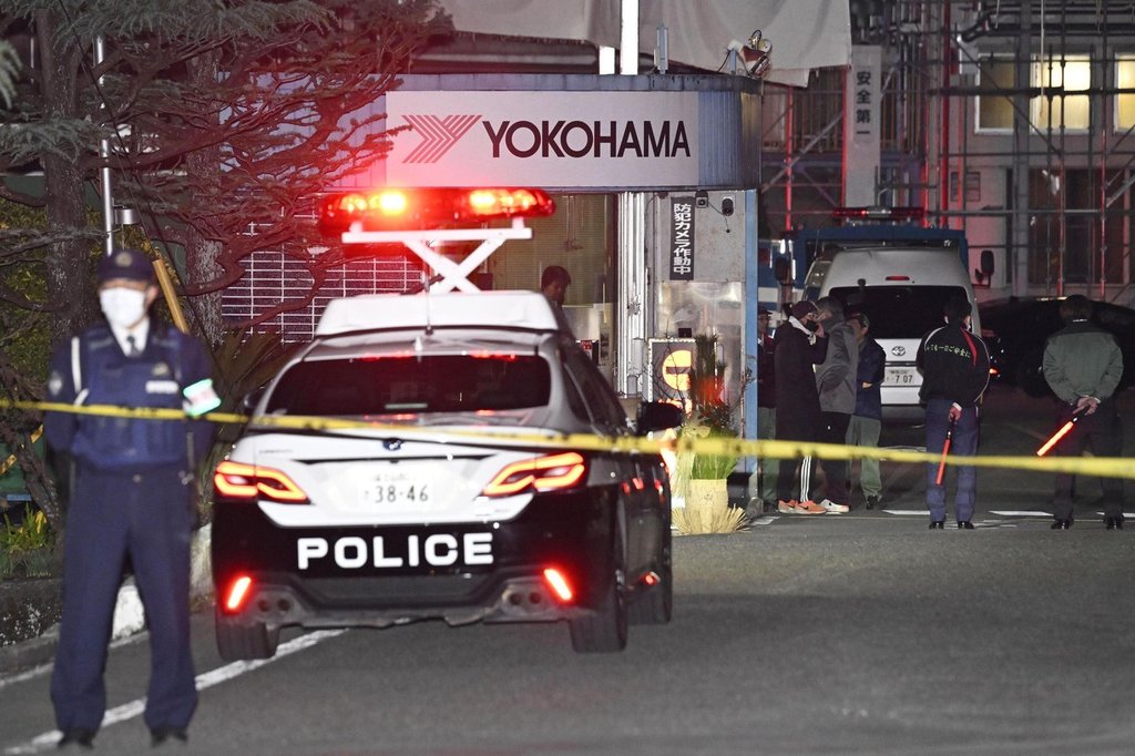 Police officers stand guard at the scene of a stabbing at the Yokohama Rubber Company in Mishima, west of Tokyo, Friday, Dec. 26, 2025. (Yusuke Hashizume/Kyodo News via AP).
