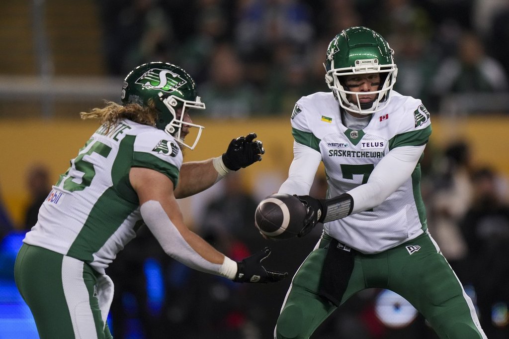 Saskatchewan Roughriders quarterback Trevor Harris (7) passes to Saskatchewan Roughriders' A.J. Ouellette (45) as they take on Montreal Alouettes in first half CFL football action at the 112th Grey Cup, in Winnipeg on Sunday, Nov. 16, 2025.
