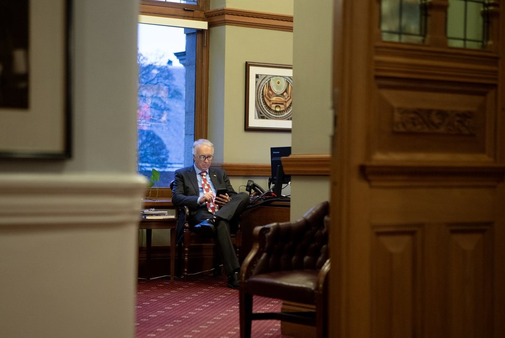B.C. Conservative Leader John Rustad checks his phone in the Office of the Speaker at the B.C. Legislature in Victoria, on Wednesday, Dec. 3, 2025. THE CANADIAN PRESS/Chad Hipolito.