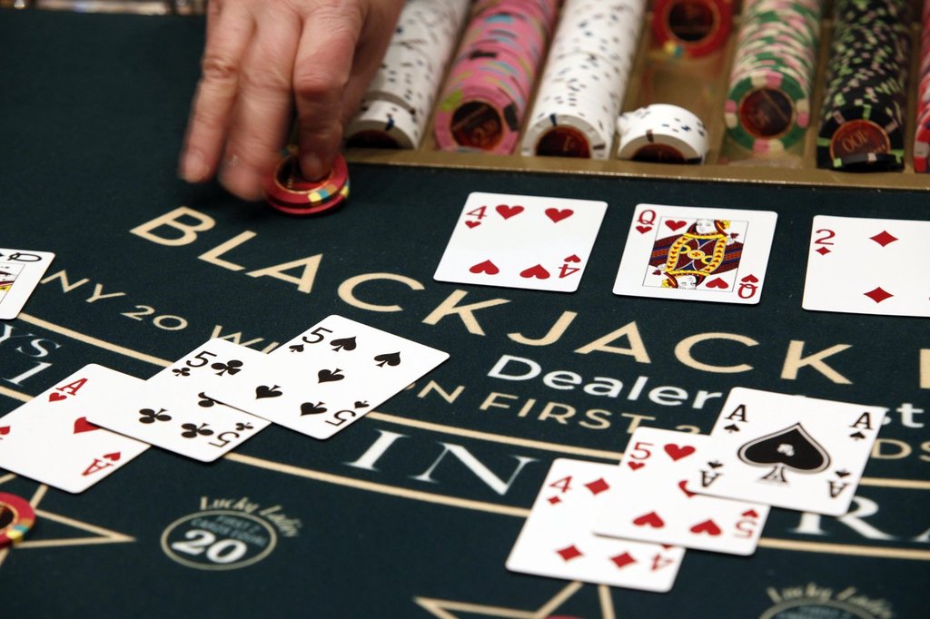 A dealer slides chips across the blackjack table on Friday, March 16, 2012, in Bangor, Maine. THE CANADIAN PRESS/AP-Robert F. Bukaty.