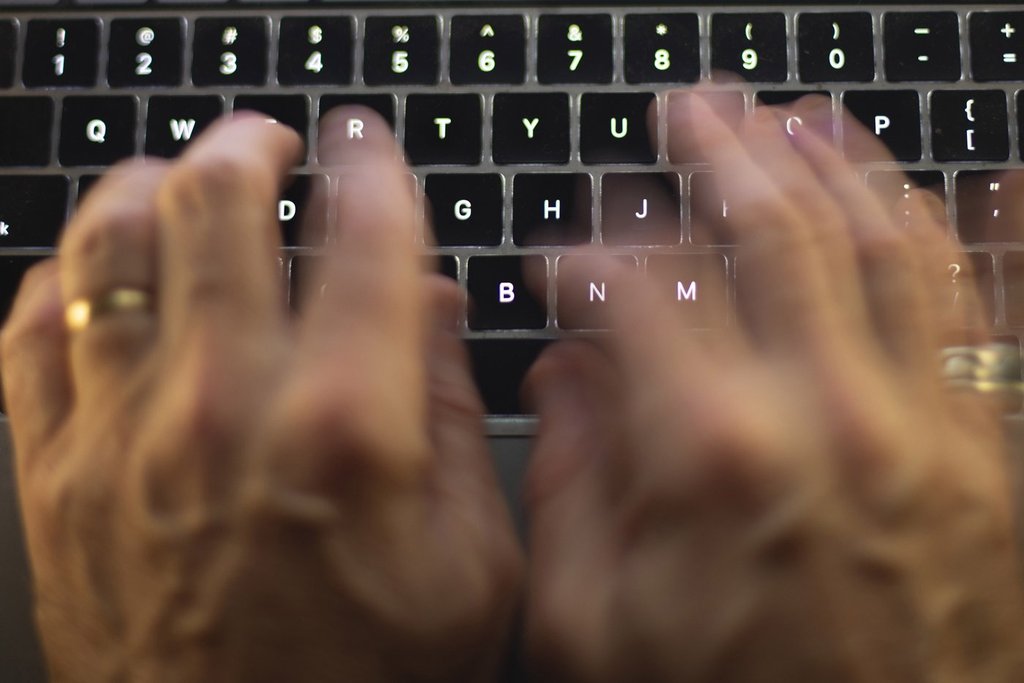 A man uses a computer keyboard in Toronto in a Sunday, Oct. 9 photo illustration. 