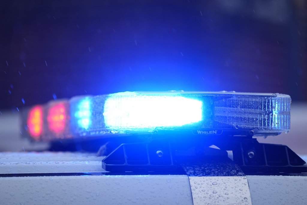 Lights on a parked police vehicle flash.