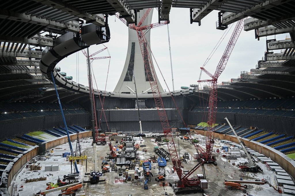 Cranes are shown inside the Olympic Stadium during the replacement of the roof in Montreal, Thursday, Jan. 8, 2026. THE CANADIAN PRESS/Graham Hughes.