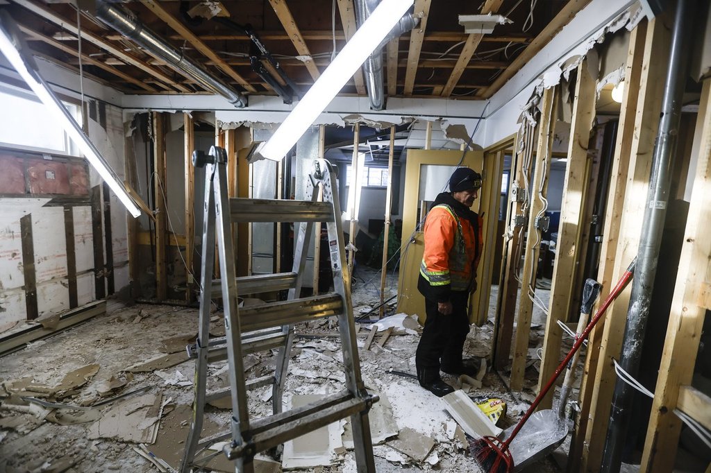 Crews work to clean up the basement of a home on the Pimicikamak Cree Nation, which was destroyed due to water damage during recent infrastructure failures, during a tour with politicians and media at Pimicikamak Cree Nation, Man., on Jan. 7, 2026. THE CANADIAN PRESS/John Woods