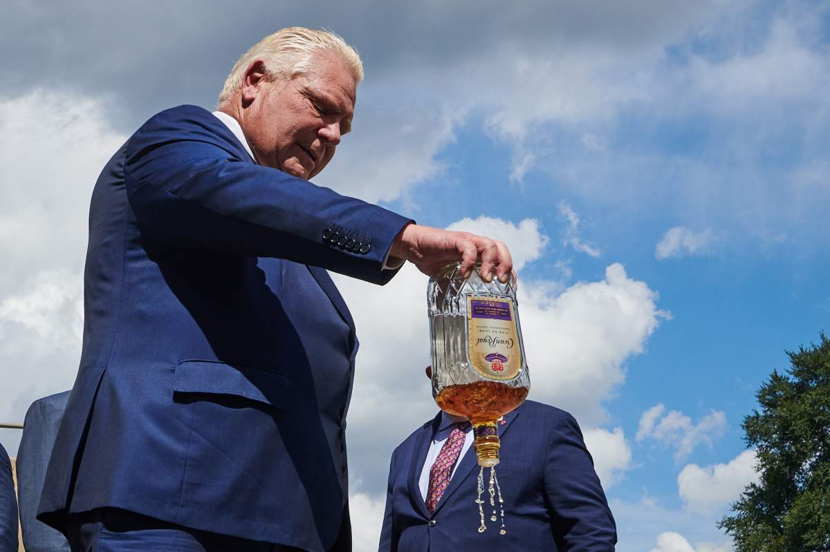 Doug Ford dumps out a bottle of Crown Royal