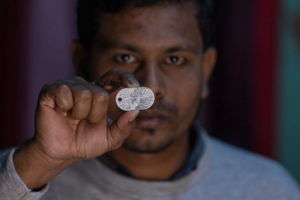 A former Russian solider shows a Russian military dog tag.