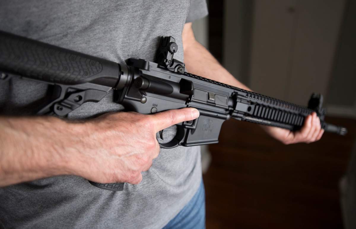 A restricted gun licence holder holds a AR-15.