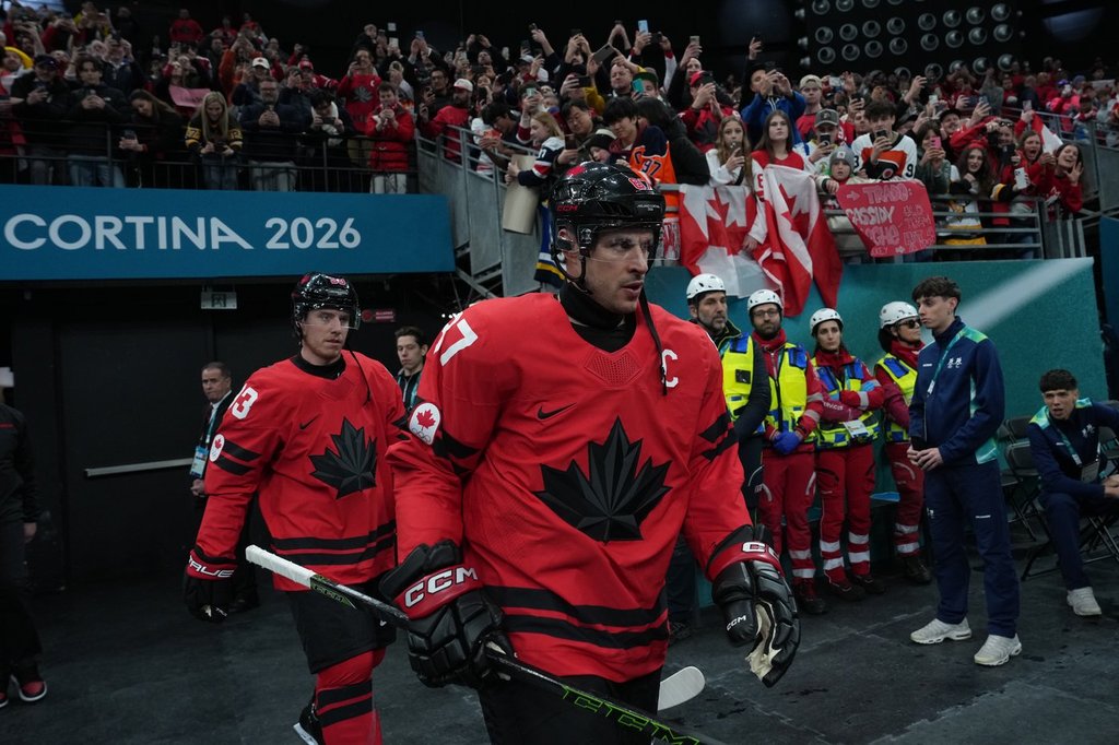 Canada's Sidney Crosby (87) and Canada's Mitch Marner (93) walk to the warm-up ahead of a quarterfinal men's hockey game against Czechia at the 2026 Winter Olympics, in Milan, on Wednesday, Feb. 18, 2026. THE CANADIAN PRESS/Darryl Dyck.
