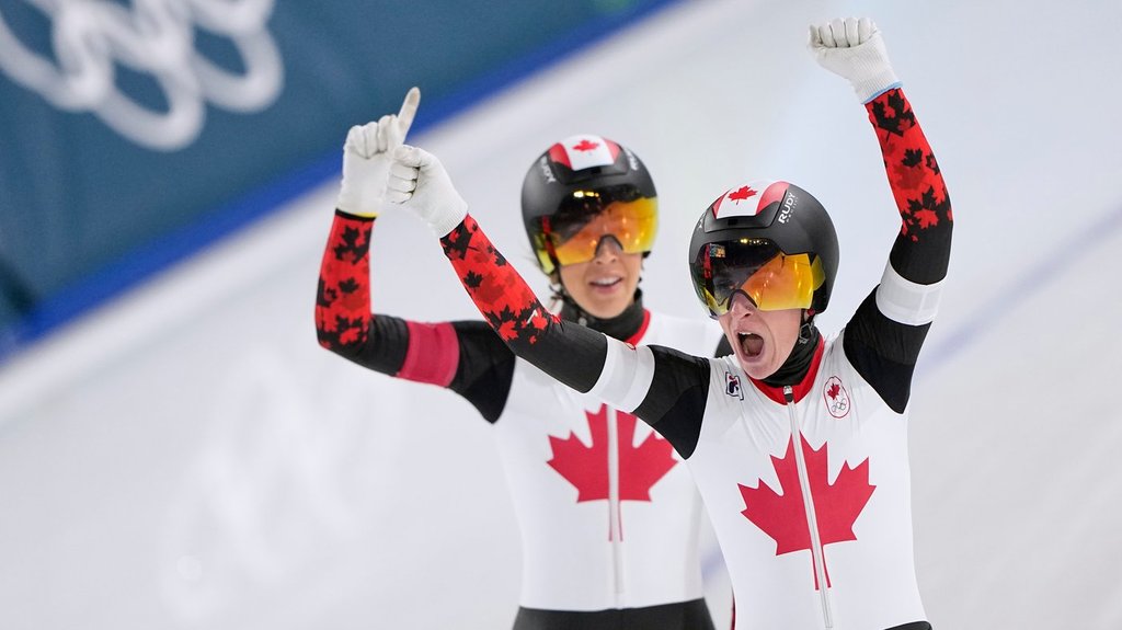 Ivanie Blondin of Canada, front, and Valerie Maltais of Canada celebrate after competing in the women's team pursuit quarterfinals speedskating race at the 2026 Winter Olympics, in Milan, Italy, Saturday, Feb. 14, 2026. (AP Photo/Ben Curtis).