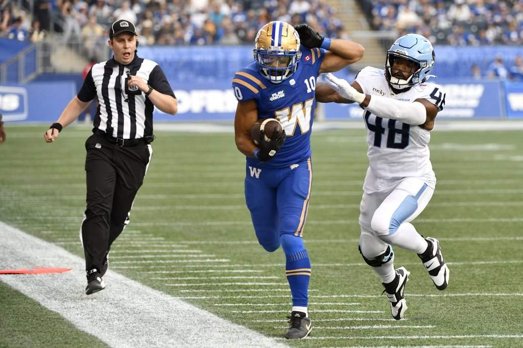 Toronto Argonauts' Wynton McManis (48) pushes Winnipeg Blue Bombers' Nic Demski (10) out of bounds after a catch during first half CFL action in Winnipeg, Friday, Aug. 1, 2025. THE CANADIAN PRESS/Fred Greenslade.