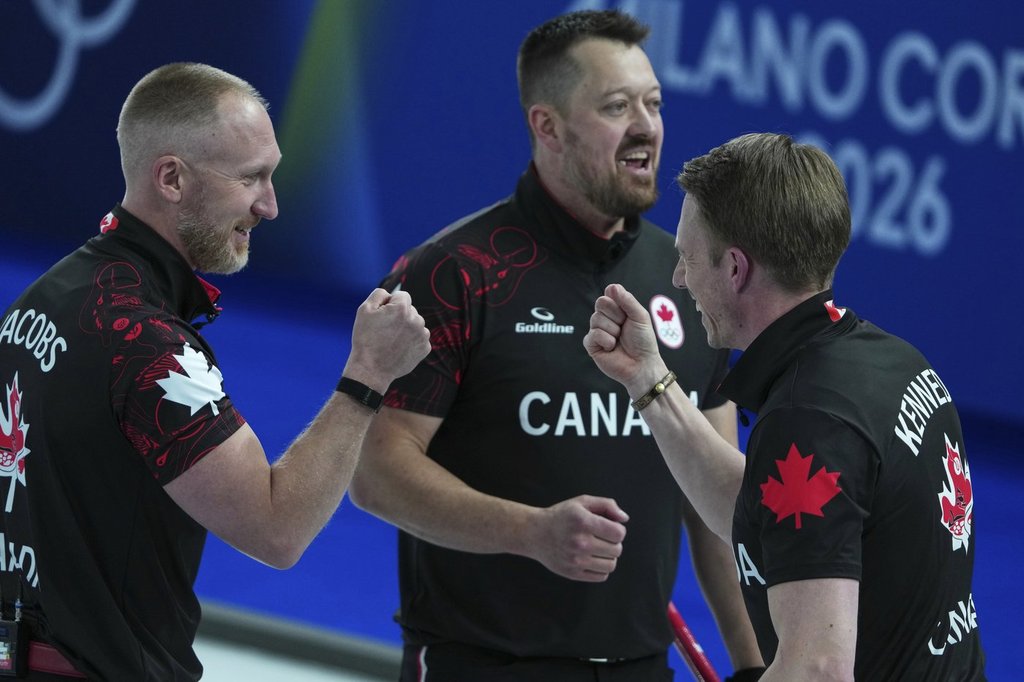 Canada's Marc Kennedy, Brad Jacobs, and Ben Hebert react after the men's curling round robin session against Sweden, at the 2026 Winter Olympics, in Cortina d'Ampezzo, Italy, Friday, Feb. 13, 2026. (AP Photo/Misper Apawu).